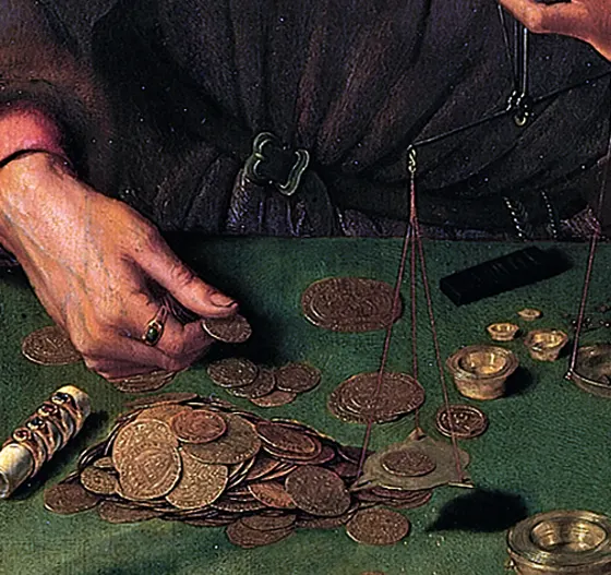 Hands weighing coins on a green cloth